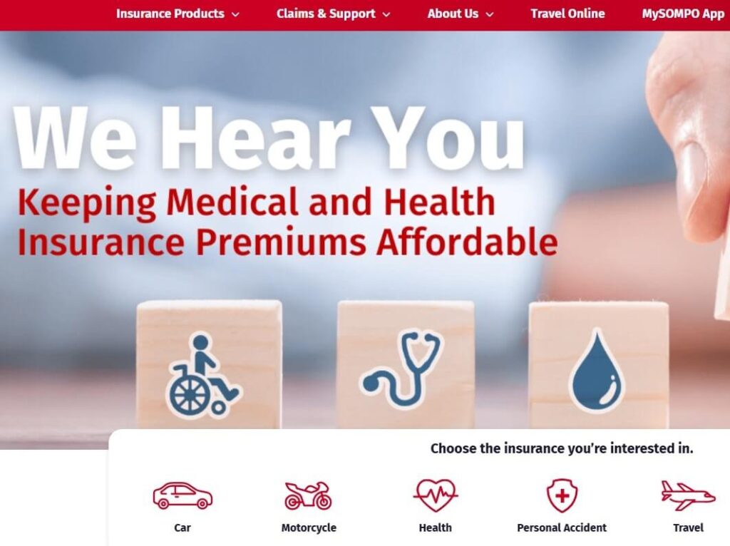 Halaman utama laman web Berjaya Sompo Insurance memaparkan tajuk besar 'We Hear You' and the subheading 'Keeping Medical and Health Insurance Premiums Affordable.' Di bawah teks terdapat tiga blok kayu yang memaparkan ikon untuk seseorang yang berkerusi roda, stetoskop dan titisan darah, yang mewakili insurans kesihatan