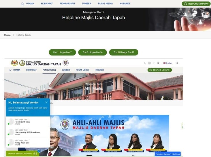 Tangkapan skrin laman web rasmi Majlis Daerah Tapah, menunjukkan halaman "Helpline" di bahagian atas dan bahagian "Ahli Majlis" di bawahnya. Imej itu juga menampilkan widget sembang dengan ucapan dan senarai ahli lembaga dalam zon tertentu, termasuk Tan Siew Ching, Saraswathy A/P Bhaskaran, dan Choy Kean Lee, ditandakan sebagai "ONLINE."