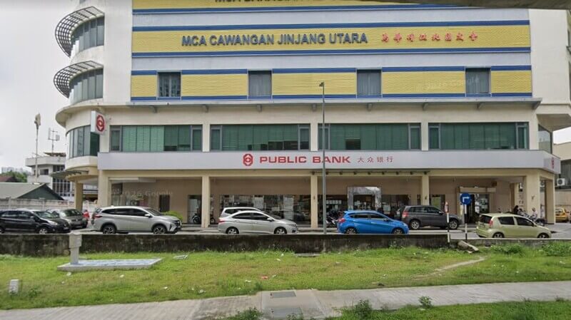 Pandangan hadapan bangunan cawangan Public Bank di Jinjang Utara dengan kenderaan diletakkan di bahagian luar.