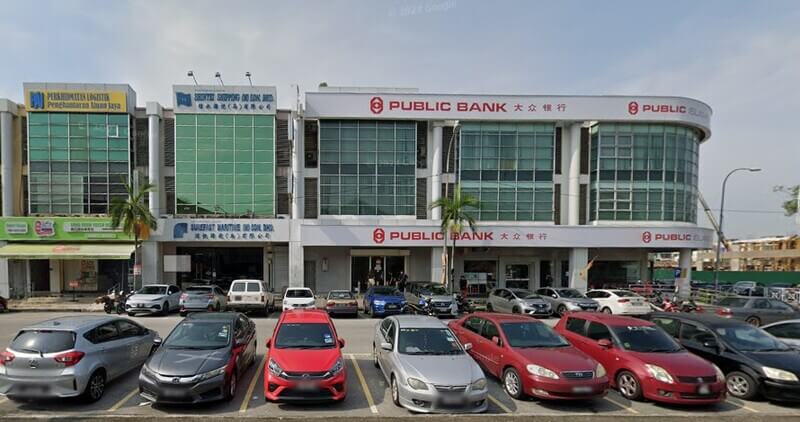 Bangunan kedai dua tingkat yang menempatkan cawangan Public Bank di Bandar Bukit Tinggi, dengan deretan kereta diletakkan di petak tempat letak kereta di hadapannya.