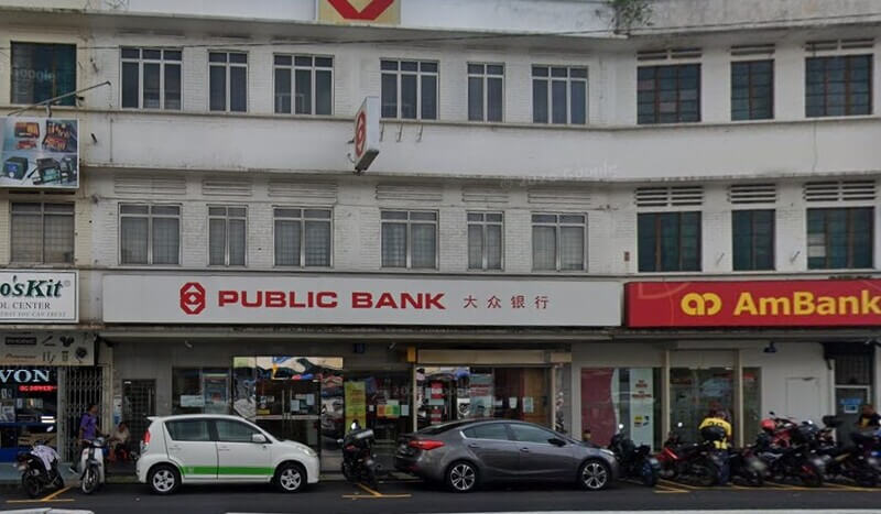 Bangunan cawangan Public Bank dan AmBank di Jalan Pasar dengan beberapa buah kereta dan motosikal diletakkan di hadapan kedai.