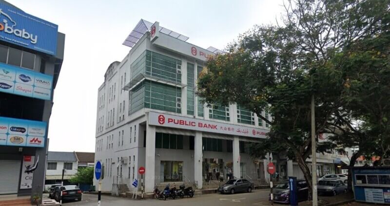 Pandangan luar bangunan Public Bank cawangan Jalan Beserah dengan tempat letak kereta dan pokok di bahagian hadapan.