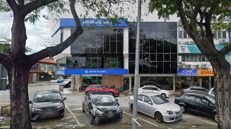 Pemandangan luar bangunan cawangan Affin Bank PJ SS2 berdepan jalan raya dengan deretan kereta yang diletakkan di petak letak kereta.