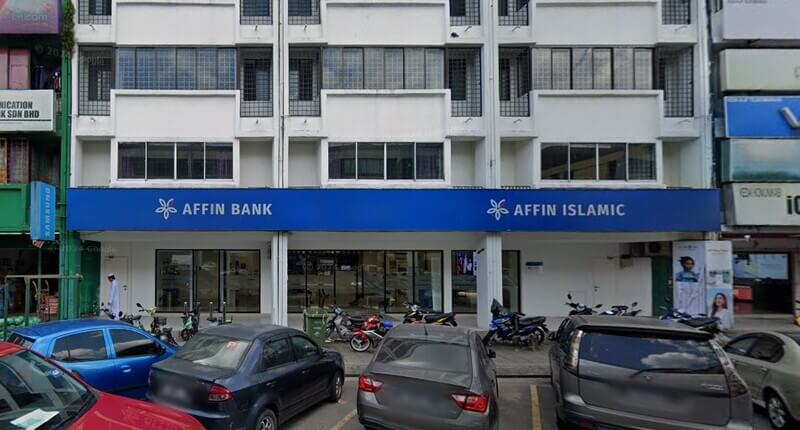Pandangan hadapan cawangan Affin Bank Selayang dan Affin Islamic pada bangunan kedai bercat putih dengan beberapa kenderaan diletakkan di bahagian hadapan.