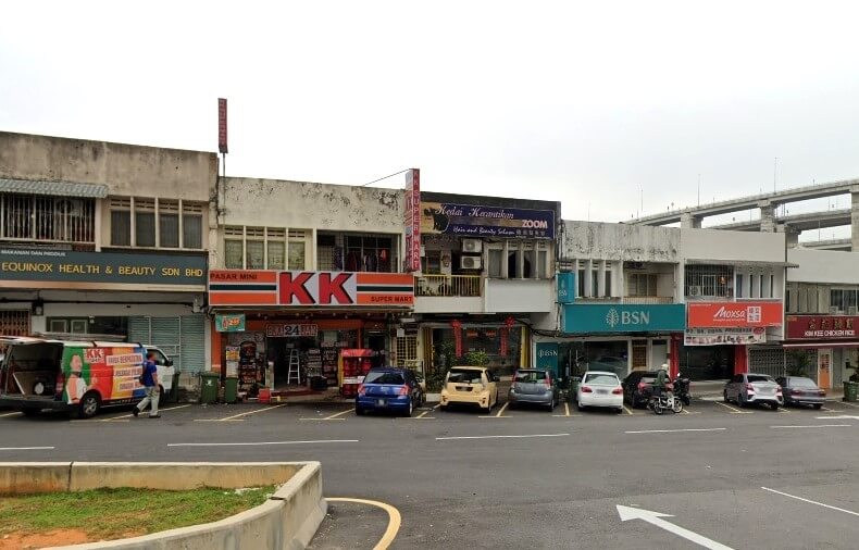 Pandangan luar deretan rumah kedai komersial kecil, termasuk cawangan BSN (Bank Simpanan Nasional), KK Super Mart, Equinox Health & Beauty Sdn Bhd, dan Kedai Keperluan Zoom (minimarket) di Taman Len Sen, Malaysia